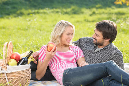 What a beautiful day! Loving young couple enjoying an intimate picnic togetherの写真素材