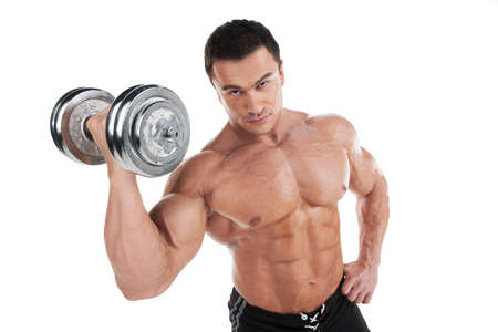 Portrait of sexy muscular man training with dumbbell. Standing isolated over white backgroundの写真素材