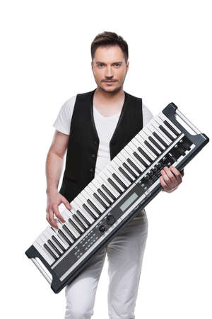 Sexy handsome man with synthesizer. Standing isolated over white backgroundの写真素材