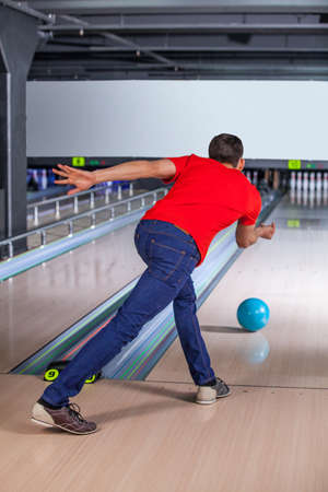 Bawling. Young man bowling, he is throwing a ball.の写真素材