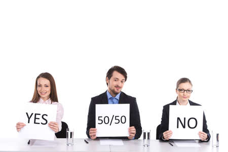 three person sitting at table holding signs. two woman and man selling legally