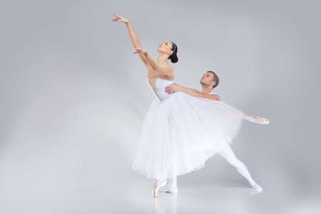 two young ballet dancers practicing. attractive dancing performers acting on stageの写真素材