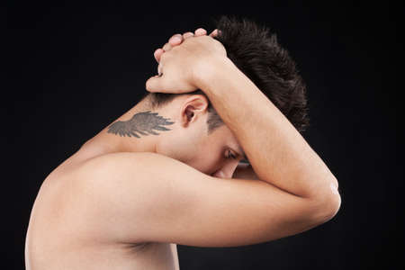  young man with tattoo on neck. cool guy with tattoo of wings on neckの写真素材
