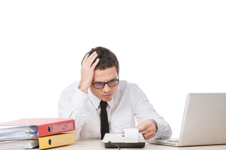 stressed young worker holding head. upset handsome man siting and thinkingの写真素材
