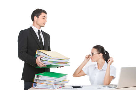young handsome man carrying folders. beautiful woman sitting surprised and stressedの写真素材