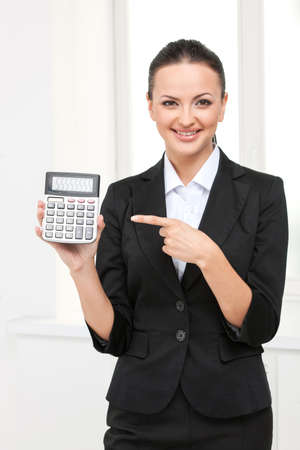 beautiful young business woman with calculator. isolated on white background smiling girlの写真素材