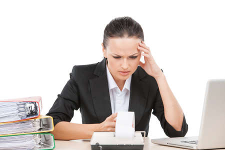 beautiful brunette girl holding head. pretty young business woman having headacheの写真素材