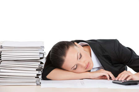 beautiful young worker sleeping on desk. attractive business woman tired and restingの写真素材