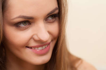 face of beautiful woman with long hair. closeup portrait of young girl smilingの写真素材