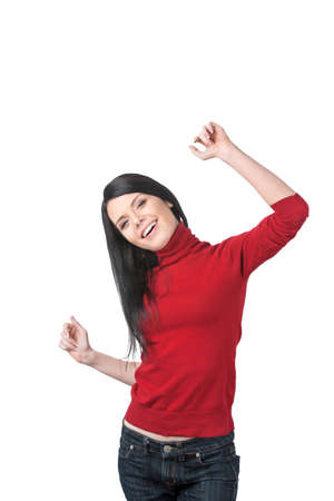 beautiful girl raising hands and smiling. young woman in red and jeans dancingの写真素材