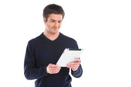 Young man waist up using tablet. handsome guy holding computer against white backgroundの写真素材