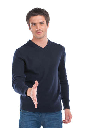 handsome young man standing on white background. portrait of guy waist up offering handの写真素材