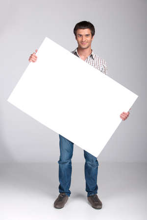 close up of man turning white board. guy showing empty space white placard の写真素材
