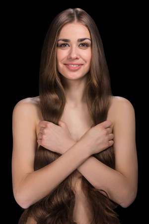 beautiful brunette girl standing on black background. の写真素材