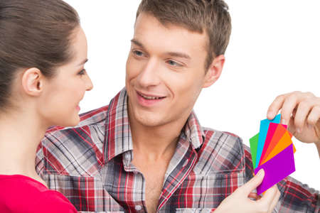 beautiful couple selecting color and smiling. man talking to woman on white backgroundの写真素材