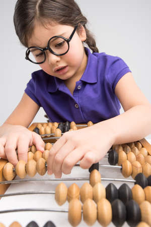 little girl playing with counting frame. nice child moving beads on counter