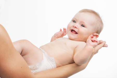 mother holding cute infant in hands. small baby lying in parent handsの写真素材