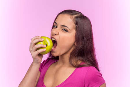 beautiful young woman eating apple. 