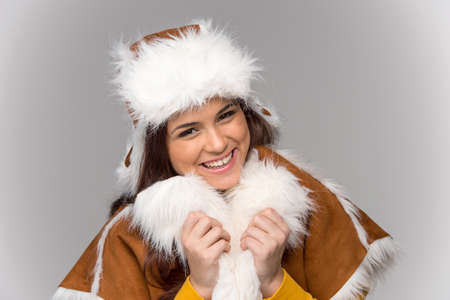 Young woman wearing winter coat. beautiful girl standing isolated over white backgroundの写真素材