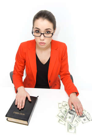 Business accountant working with bible and money. Young worried woman with bible and money on table