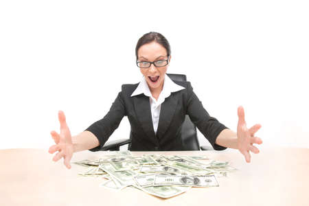 Young businesswoman looking at money scattered on table. happy and excited woman sitting at the...