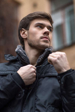 Close up portrait of trendy young man. handsome young man standing outdoors の写真素材