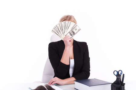 Charming mature businesswoman sitting at table. successful businesswoman with her money on whiteの写真素材