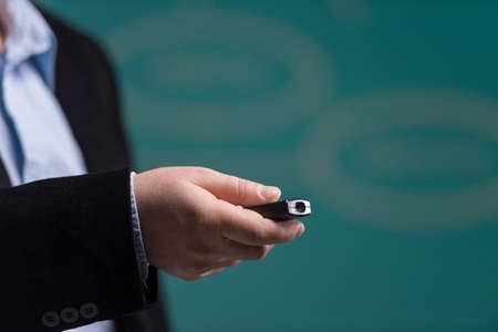 man hand holding laser pointing. man standing with laser pointer on green background. man hand holding laser pointing. man standing with laser pointer on green background.