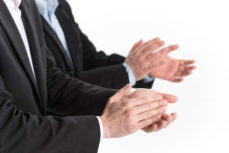 Photo of business people hands applauding at white background. Photo of business partners hands applauding at meeting の写真素材