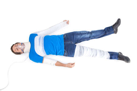 young man lying with cervical collar. top view of young man with broken hand in gypsumの写真素材