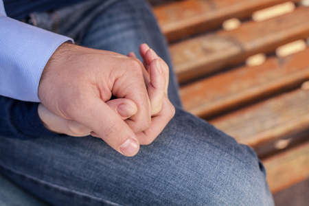 Happy couple holding hands in park. two people holding hands on bench
