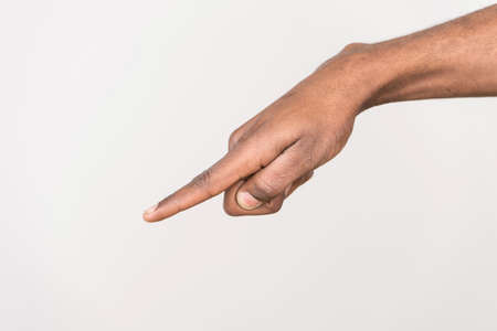 black man hand on white background. isolated african male hand touching or pointing to somethingの写真素材
