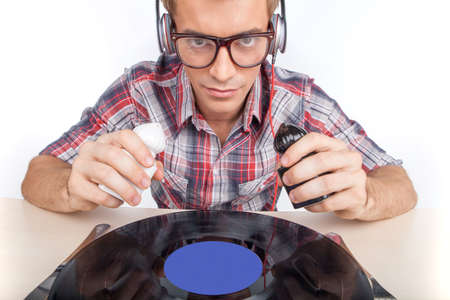 Young man working as dj with ear-phones and glasses. 