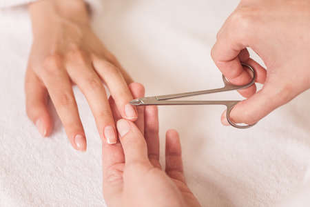 Close up of female hands on towel at spa salon. の写真素材