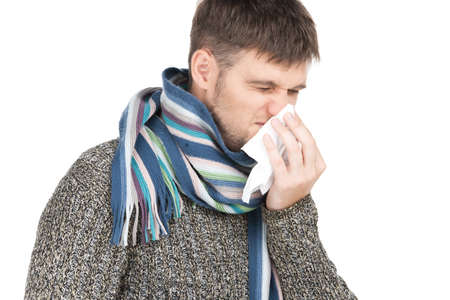 allergy man blowing his nose in tissue paper. の写真素材