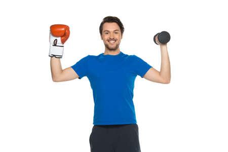 handsome man standing on white background. guy wearing boxing gloves and holding dumbbellsの写真素材