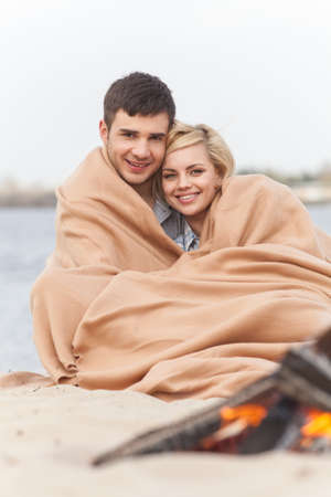 happy couple having fun around bonfire. の写真素材