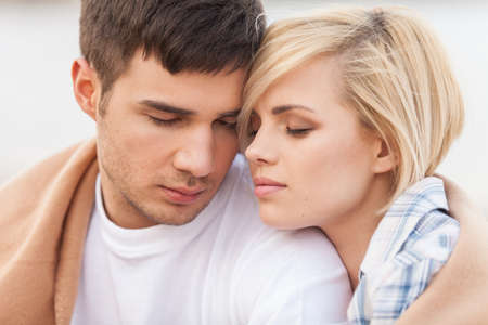 Attractive young couple standing on beach at summer. の写真素材