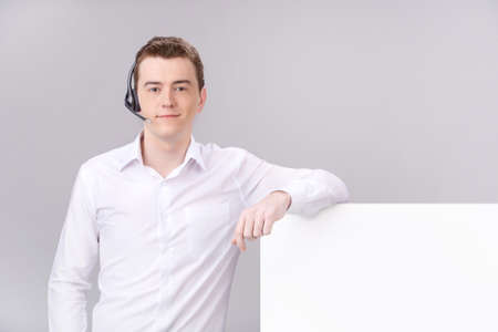 Call center male operator isolated on white with blank. の写真素材