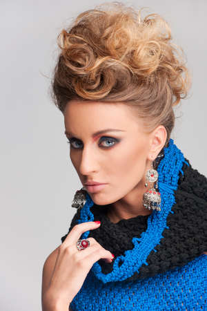 beautiful blonde woman wearing blue dress. closeup on pretty girl looking into cameraの写真素材