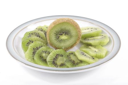 Kiwi fruit slices on saucer isolated on white backgroundの写真素材