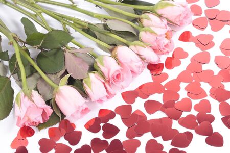 Pink roses and valentine heart shapes on whiteの写真素材
