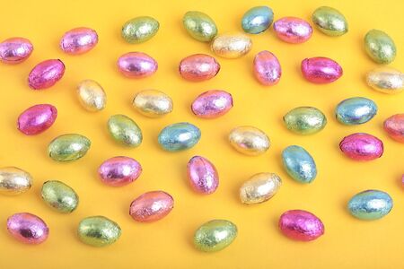 Easter eggs over yellow backgroundの写真素材