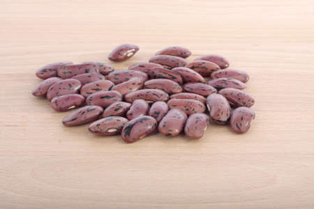 Runner bean seeds on wooden chopping board