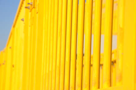 close up of the pattern of vertical bright yellow stair railingsの写真素材