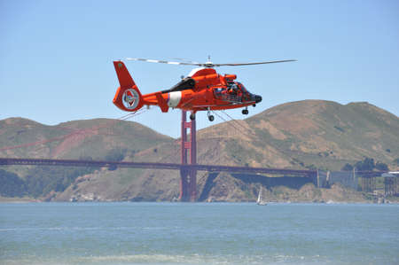 Rescue helicopter and the San Francisco Bridgeの写真素材