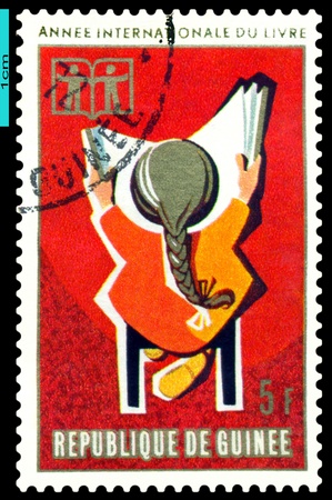 REPUBLIQUE  DE GUINEE - CIRCA 1972: A Stamp printed in the Republique de Guinee shows  Children  and  Book, series, circa 1972の写真素材