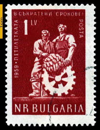 BULGARIA - CIRCA 1959: A stamp printed by  Bulgaria shows  Worker and  Peasant with cogfheel,  circa 1959の写真素材