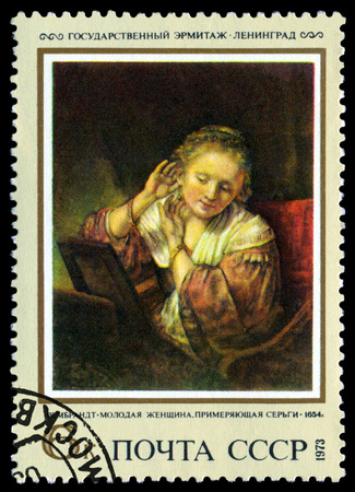 USSR - CIRCA 1973  a stamp printed by USSR   shows  a picture Woman Truing on Earrings, by Rembrandt, 1654,  series  Rembrandt  Paintings in Hermitage, circa 1973の写真素材