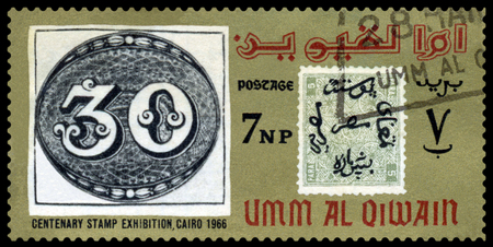 UMM  AL QIWAIN - CIRCA 1966  a stamp printed by  Umm al Qiwain  shows Emblem Philatelic Exhibition Cairo 1966, circa 1966のeditorial素材